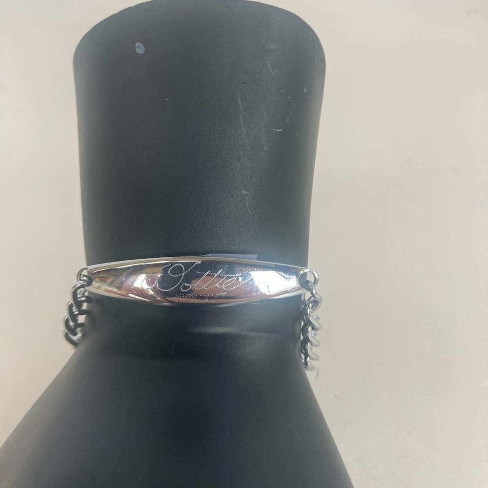 Z55-Costume jewelry-Silver colored bracelet that is engraved “Dottie”.